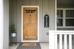 Our front door with a welcoming sign and a cozy seating area to enjoy a morning coffee or evening glass of wine while watching the deer graze. Although, most guests actually enter from the back door as they park in the garage.  